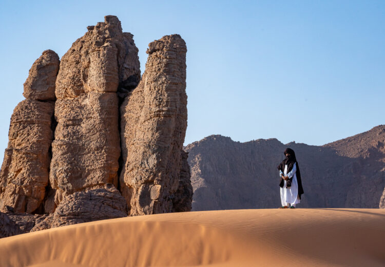 A Tuareg man adorns a spectacular corner of the Sahara close to the town of Djanet in southern Algeria (image by Inger Vandyke)