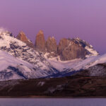 Patagonian skies can run the gauntlet of colours from indigo to orange. Here, the first light of dawn turns the sky purple over the iconic Torres del Paine mountains (image by Virginia Wilde)