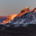 The first light of morning hits the Paine Massif and turns it orange, as if ablaze with colour. Sunrises and sunsets in Patagonia can be a spectacular sight (image by Virginia Wilde)