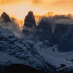 A fiery sunset turns the sky above the iconic Torres del Paine ablaze, as the fading day casts the mountains into shadow (image by Virginia Wilde)