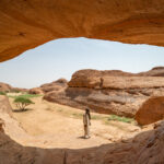 Our Chadian driver in one of the beautiful arches of the Ennedi at La Grande Vache (image by Inger Vandyke)