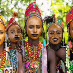 Young Wodaabe men gather in the shade before they celebrate the Gerewol Festival (image by Inger Vandyke)