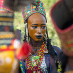 Shooting through the group of dancers to a solo Wodaabe young man taking a break in the Gerewol (image by Inger Vandyke)