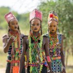 A trio of Wodaabe boys walk towards the dance arena of the Gerewol Festival (image by Inger Vandyke)