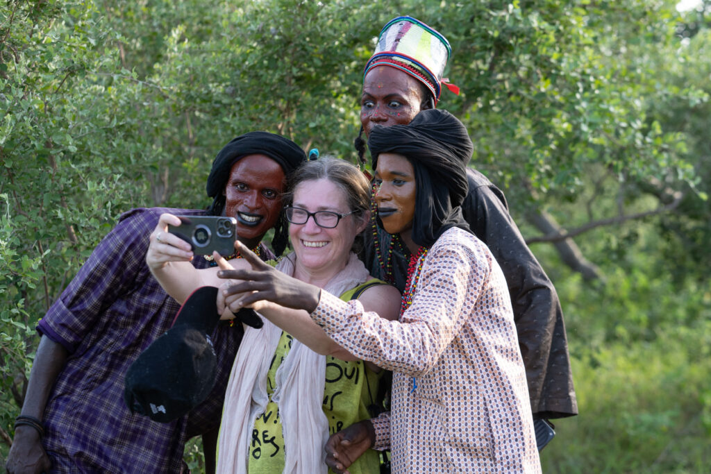 Wild Images guest Nat enjoying a group photo session with the young Wodaabe men (image by Inger Vandyke)