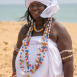 A beautiful Voodoo Adept (Priestess) arrives at the annual voodoo festival in Benin (image by Inger Vandyke)
