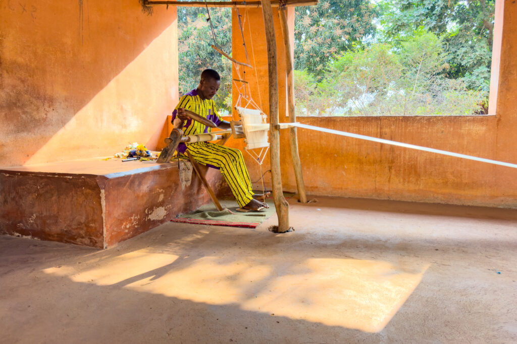 One of the talented weavers of Abomey cloth at the Palace of Agonglo (image by Inger Vandyke)