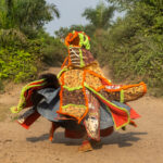 An Egungun twirling as he exits the sacred forest (image by Inger Vandyke)
