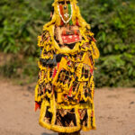 Portrait of an Egungun masked dancer against the backdrop of a sacred forest (image by Inger Vandyke)