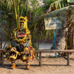 Egungun dancing is hard work, often calling for a rest! (image by Inger Vandyke)