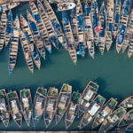 The line of fishing pirogues moored up in Elmina's harbour (image by Inger Vandyke)