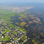 At the water's edge, the community of Ganvie with its fish farms spreading into Lake Nokoue (image by Inger Vandyke)