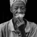 An elderly Holi man smoking a cigarette (image by Inger Vandyke)