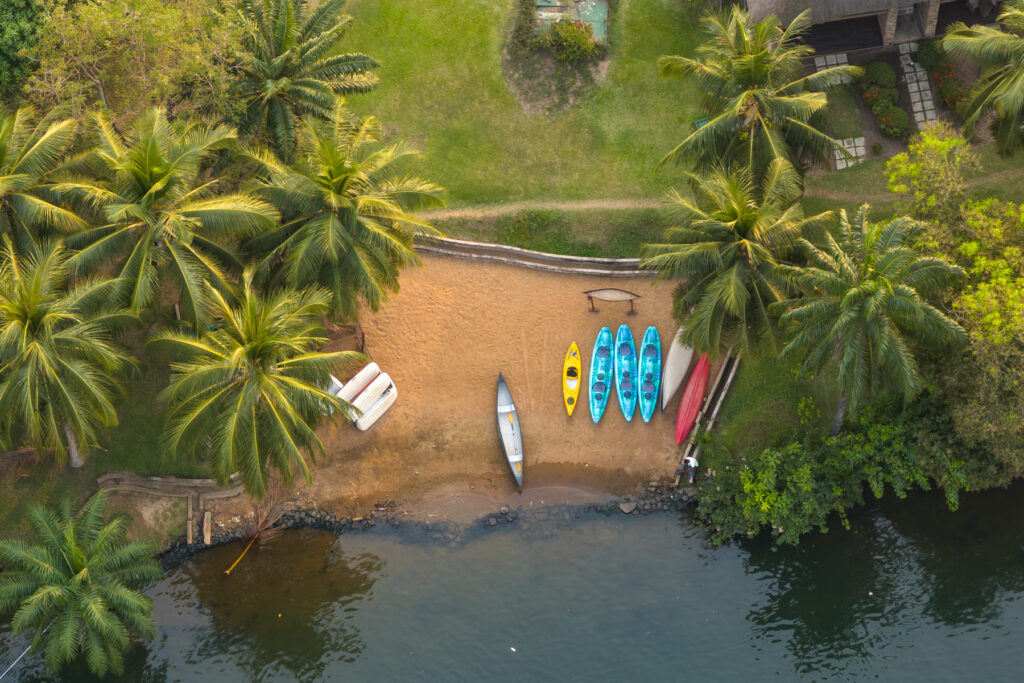 Kayaks waiting for action on a beach at the side of the Volta River in Ghana (image by Inger Vandyke)