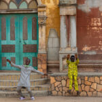 Young guys goofing off in front of the old mosque in Porto Novo (image by Inger Vandyke)