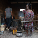 Adra making Adinkra cloth paint in her workshop (image by Inger Vandyke)