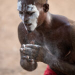 A male Gambada dancer covers his face in Kaolin (image by Inger Vandyke)