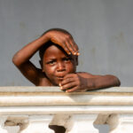 Portrait of a young Tofinu boy joking for photos (image by Inger Vandyke)
