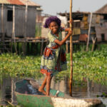 A pretty Tofinu girl poling her canoe through the canals of Ganvie (image by Inger Vandyke)