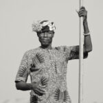 A Tofinu man smiling as he poles his canoe through Ganvie (image by Inger Vandyke)