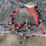 A heart of fishermen bringing in the nets of a moonboat (image by Inger Vandyke)