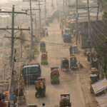 The crazy lines of power poles adorning a riverside street in Dhaka (image by Inger Vandyke)