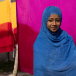A young girl in the fabric dying area (image by Inger Vandyke)