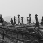 Each day thousands of workers carry loads of coal, sand and rocks from boats to the shore in Bangladesh (image by Inger Vandyke)
