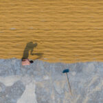 Sweeping rice to dry in the sun (image by Inger Vandyke)