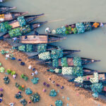Beautiful wooden river boats carrying vegetables to the market (image by Inger Vandyke)