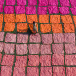 A young girl spreading fabric out to dry (image by Inger Vandyke)
