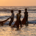 Young boys hauling Moonboat nets at sunset (image by Inger Vandyke)
