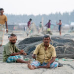 Mending nets on the beach (image by Inger Vandyke)