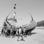 Men work in unison to land a Moonboat (image by Inger Vandyke)