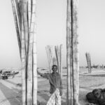 Portrait of an old fisherman standing in the anchorage bamboos of the beach at Chittagong (image by Inger Vandyke)