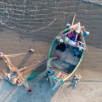 Men prepare the nets to load onto a traditional Moonboat (image by Inger Vandyke)