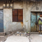 A young boy takes a break from ship breaking (image by Inger Vandyke)