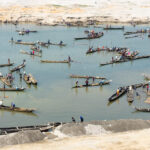 Many canoes are used to mine stones from the river (image by Inger Vandyke)