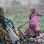 A woman works to pick waste in Bangladesh (image by Inger Vandyke)