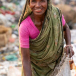 Warm smile of a woman working as a waste picker (image by Inger Vandyke)