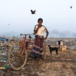 The patriarch of a waste picking family taking a cigarette break (image by Inger Vandyke)