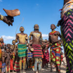 Young Dassanech men and women dance to celebrate Micha, or the first time the families of a bride and groom will meet (image by Inger Vandyke)