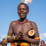 A smiling Dassanech elder, the father of the future groom, at a ceremony of Micha (image by Inger Vandyke)