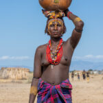 A Dassanech woman carrying a decorative gourd to the ceremony of Micha (image by Inger Vandyke)