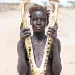 A Diyes woman holding the lower jaw of a Nile Crocodile. On average if you multiply the size of a crocodile jaw x 7 you will get the total length of the animal. We estimated this crocodile would have been around 18ft long, or around 4 times her size! (image by Inger Vandyke)