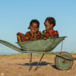 Gabra children playing in a wheelbarrow (image by Inger Vandyke)