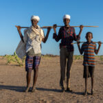 Gabra men and young boy after taking their camels out to graze in the Chalbi (image by Inger Vandyke)