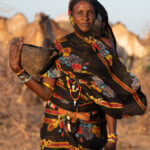 A Gabra woman carrying camel milk in a waxed bowl (image by Inger Vandyke)