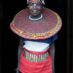 A Pokot woman dressed in an elaborate Karen disc necklace to attend a ceremony (image by Inger Vandyke)