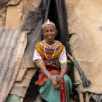 An elderly Rendile woman sitting in the doorway of a prominent council house in the Ndoto Mountains (image by Inger Vandyke)